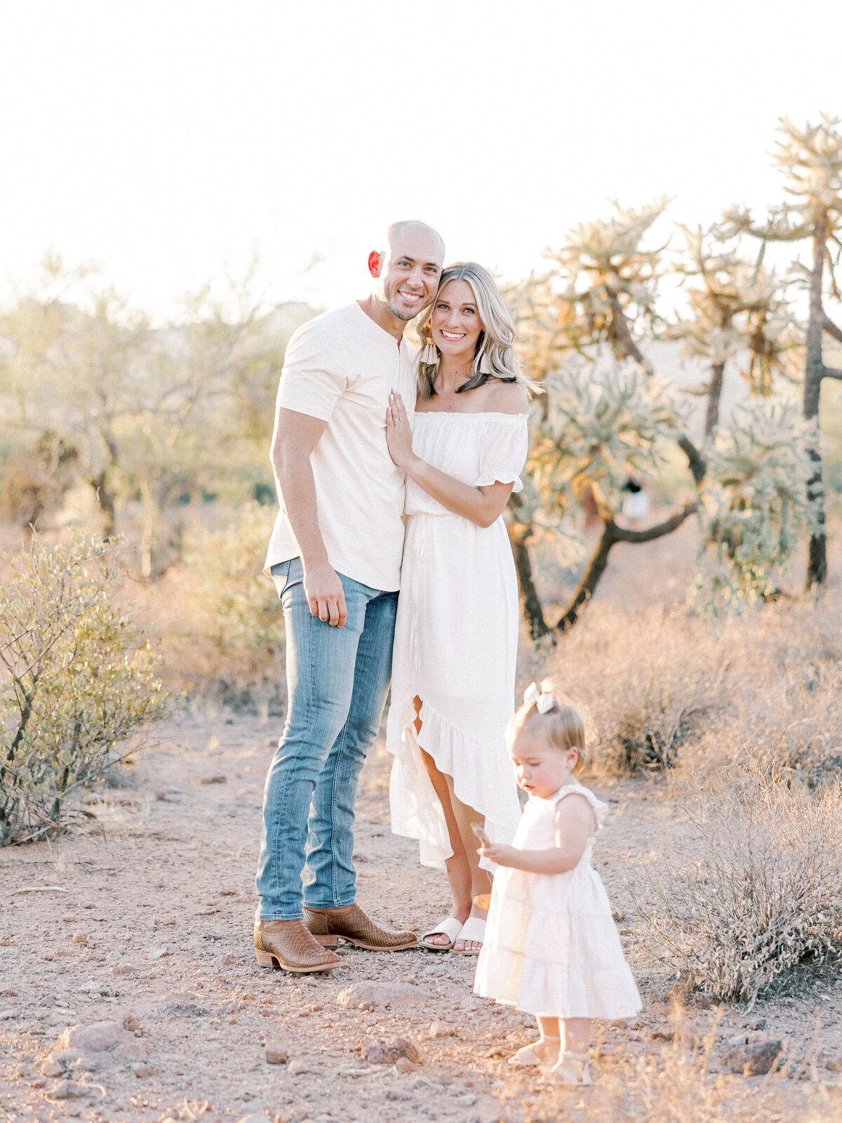 Man and woman posing with young girl in a desert