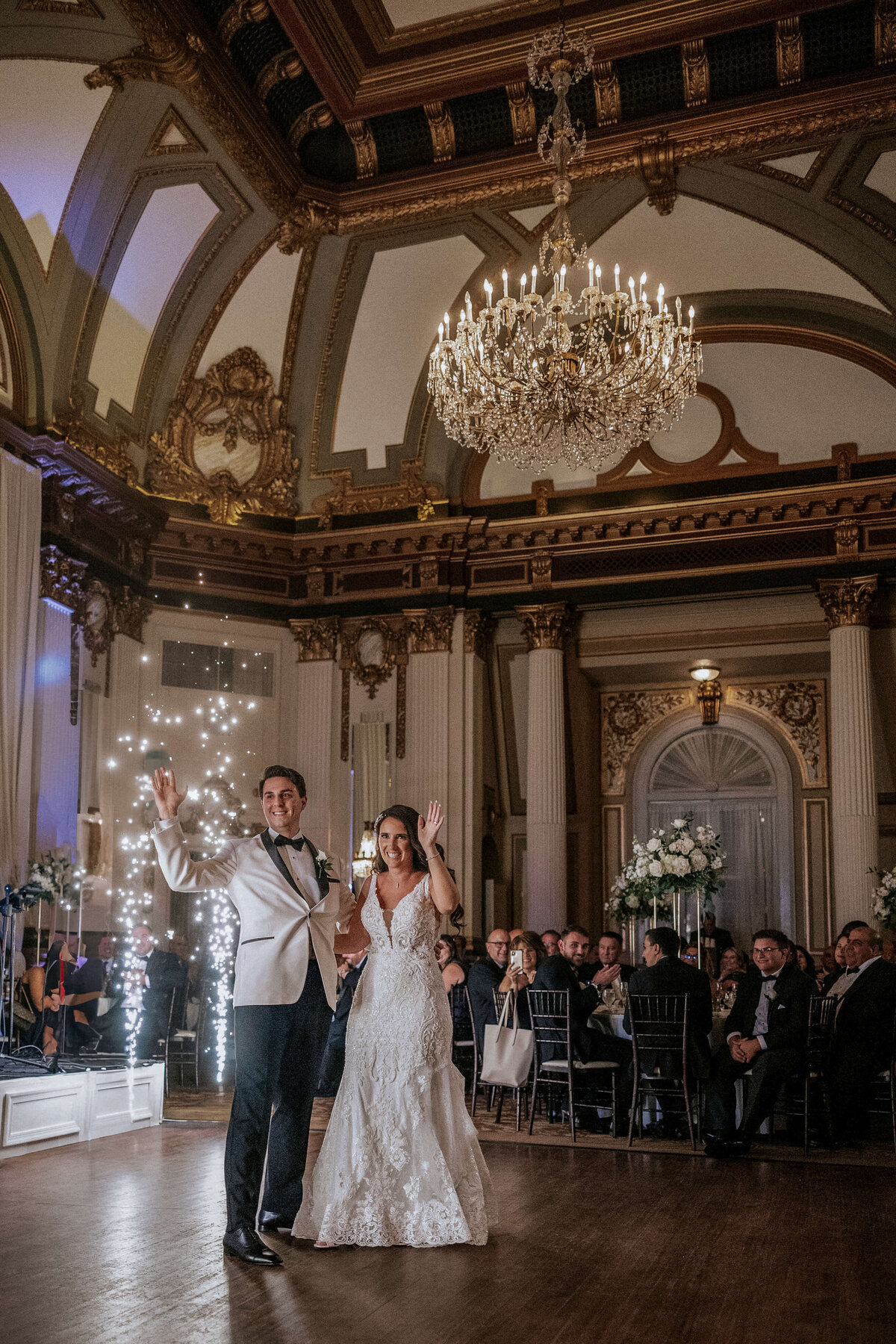 bride-and-groom-waving-next-to-cold-sparklers