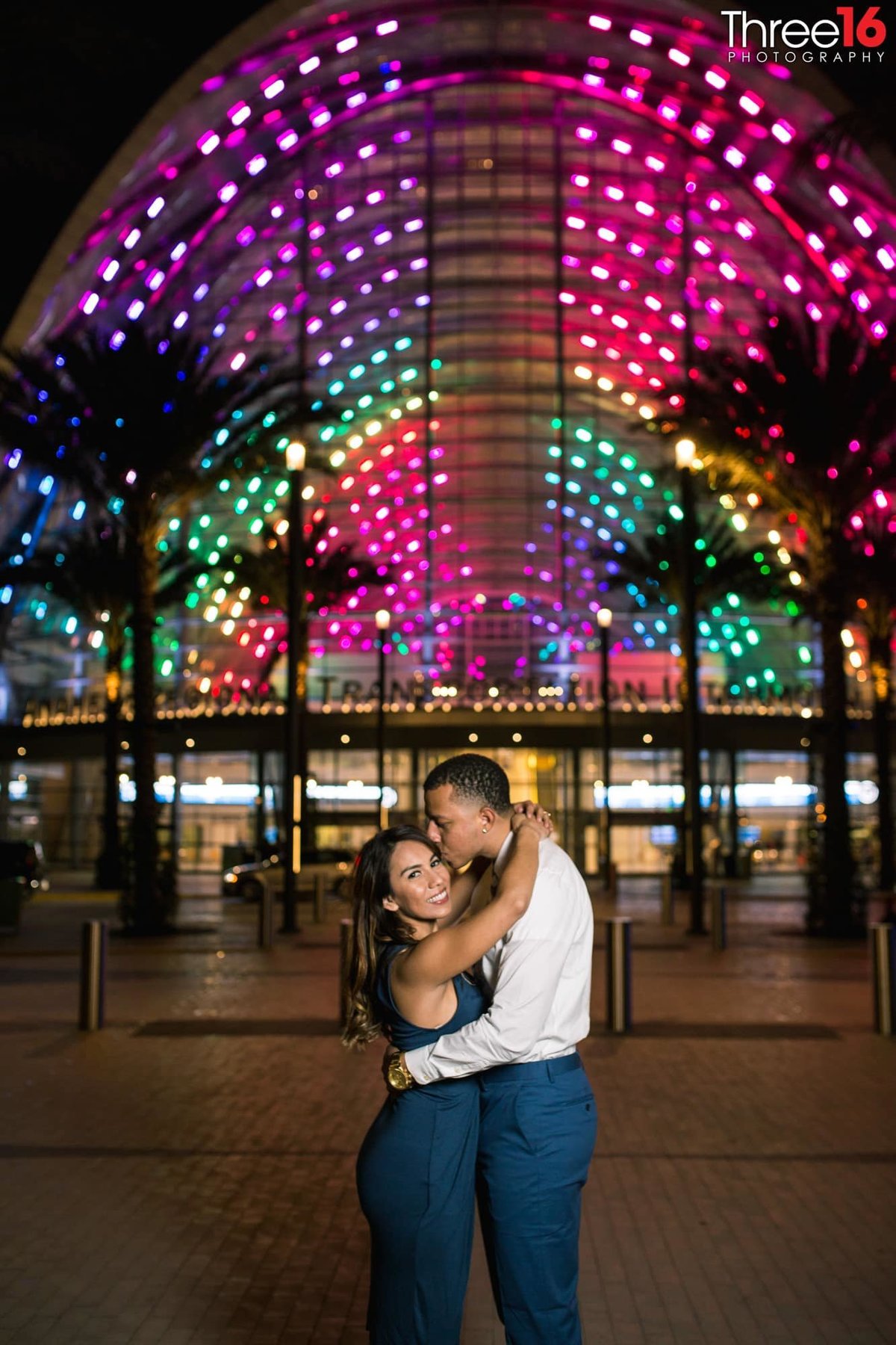 Beautiful background lights from the ARTIC Train Station during engagement session