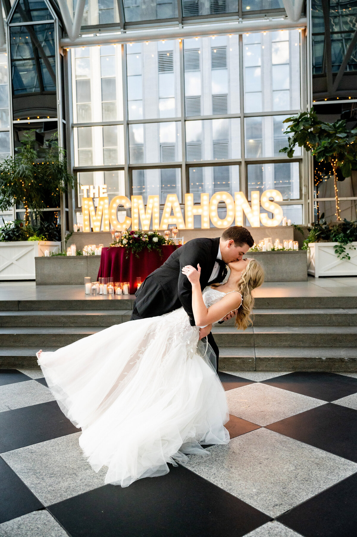 couple kissing and dipping to celebrate their wedding at wintergarden ppg place
