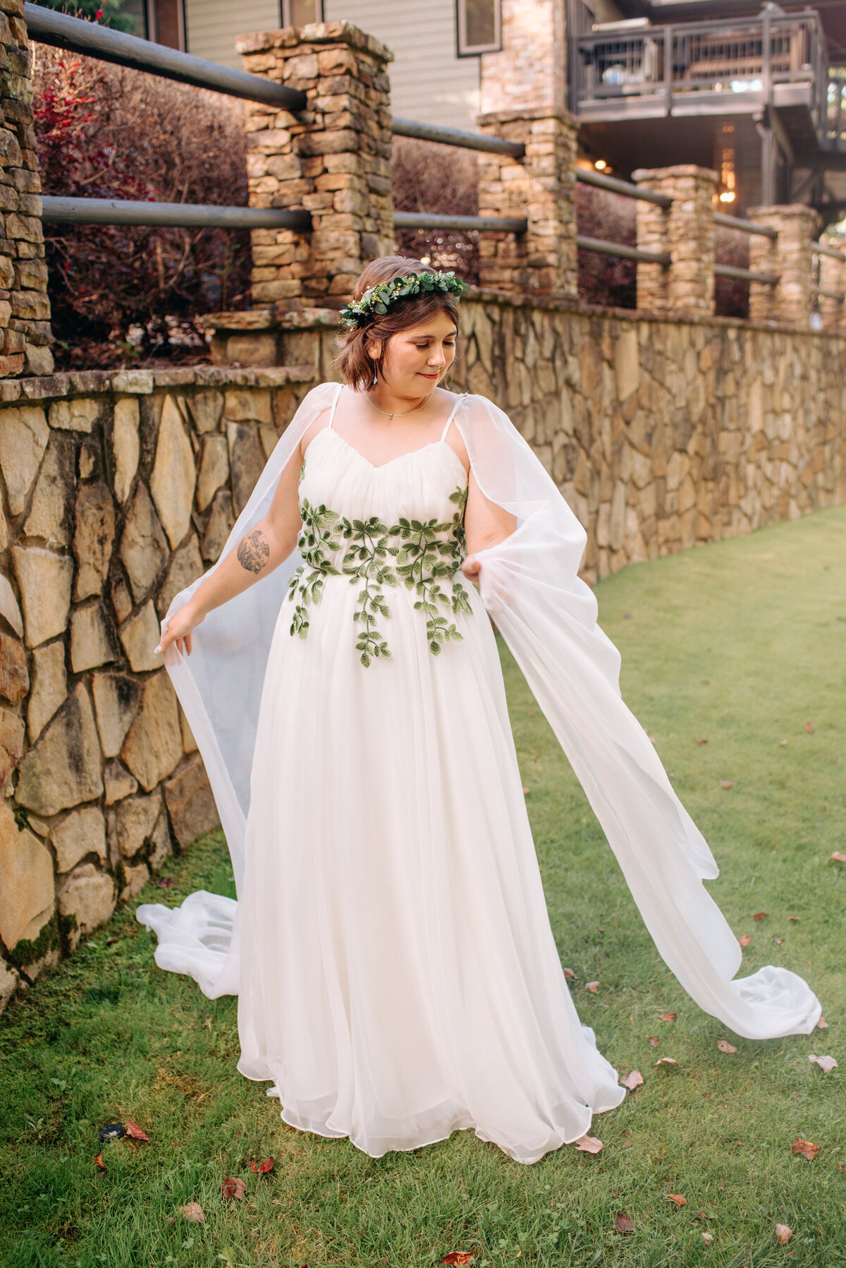 A newlywed stands in a white wedding dress