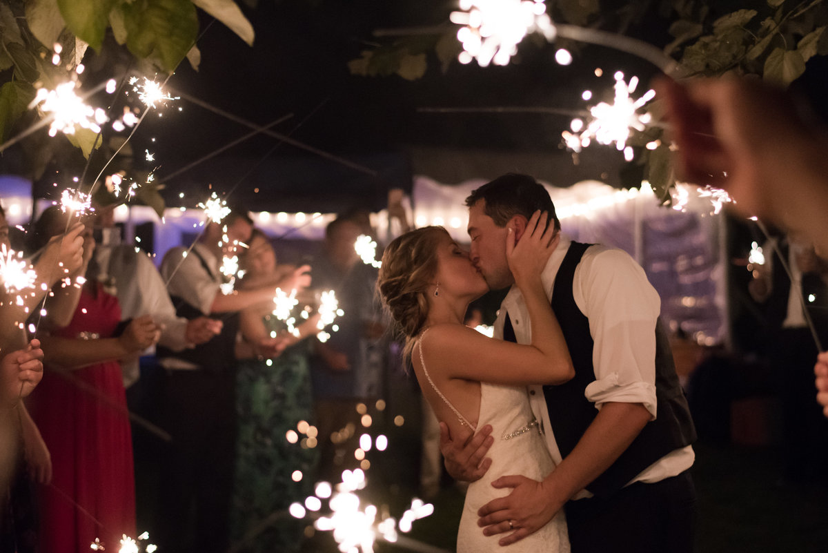 bride and groom kiss under sparkler exit from kilmarnock virginia wedding by norfolk wedding photographer