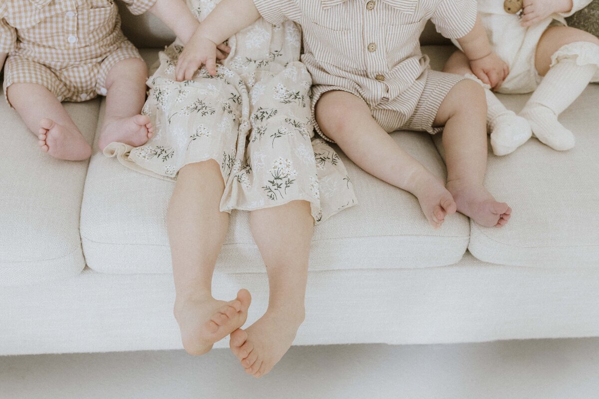 Indoor studio family session focused on children's details with creamy neautral colors