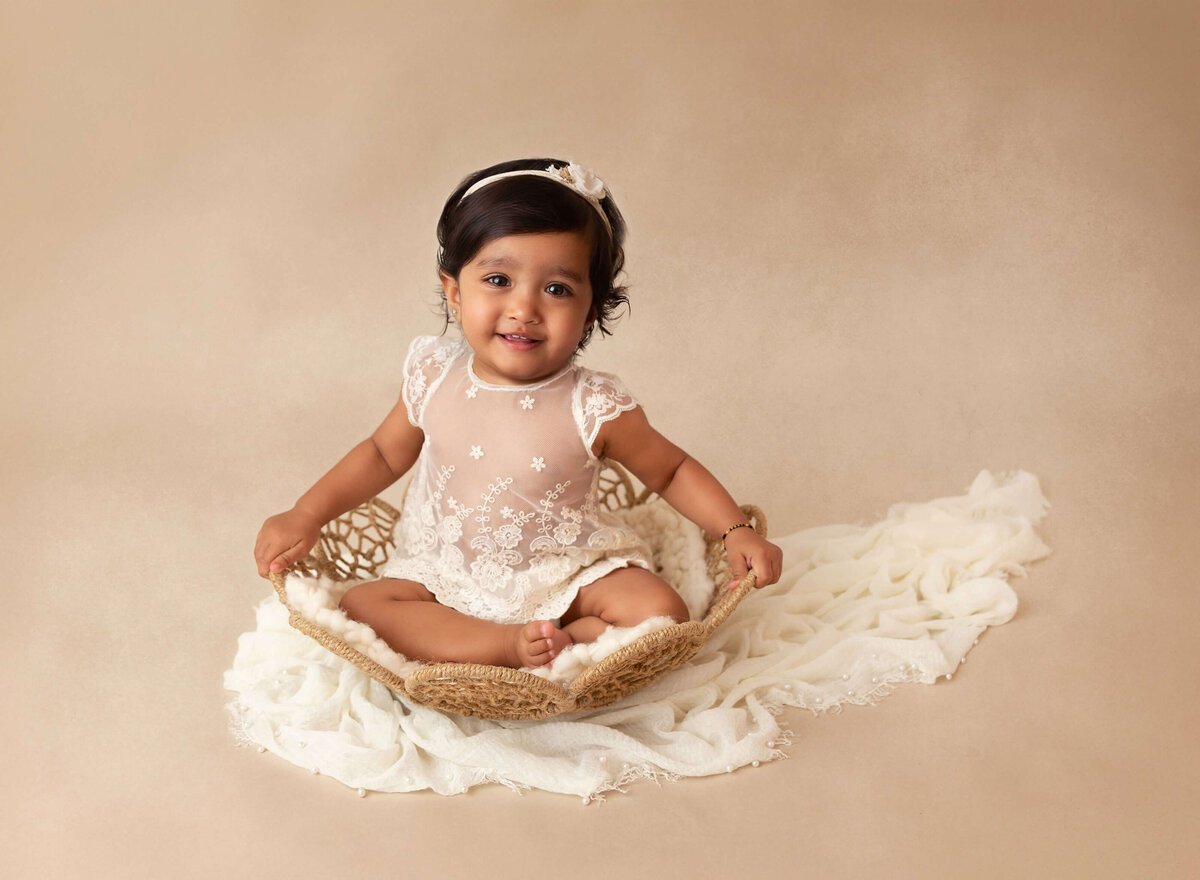 Baby girl posing for her baby photoshoot by NYC baby photographer