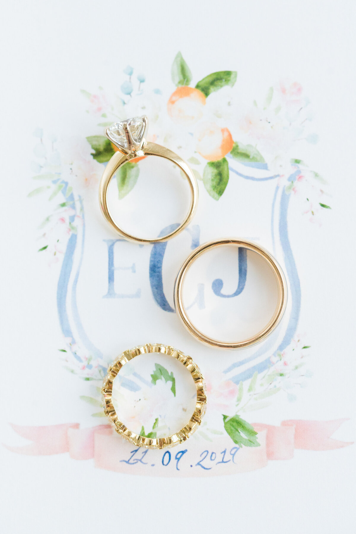 wedding rings styled on invitation crest