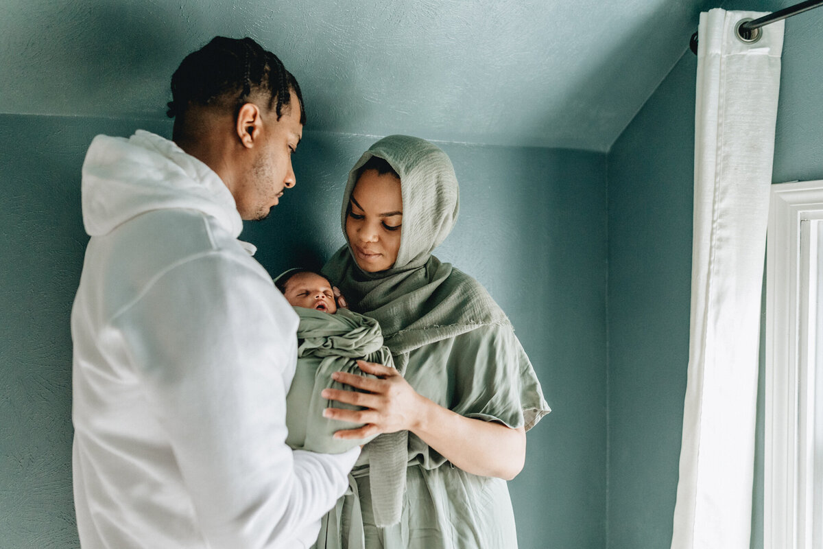 Family Photoshoot Session with dad and mom holding newborn baby.