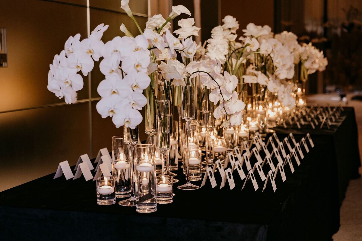 place card table with white flowers and candles by Philadelphia Wedding Florist Sebesta Design
