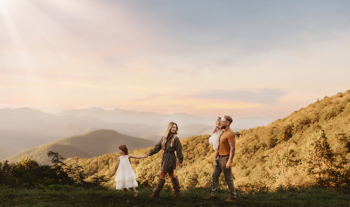 Family walks along the Blue Ridge Parkway during their Fall Family Photos in Asheville, NC.