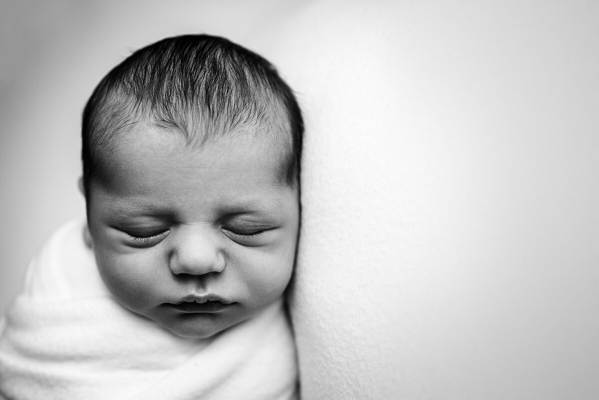 Black and white in home studio close up photo of baby boy in Jacksonville, FL.