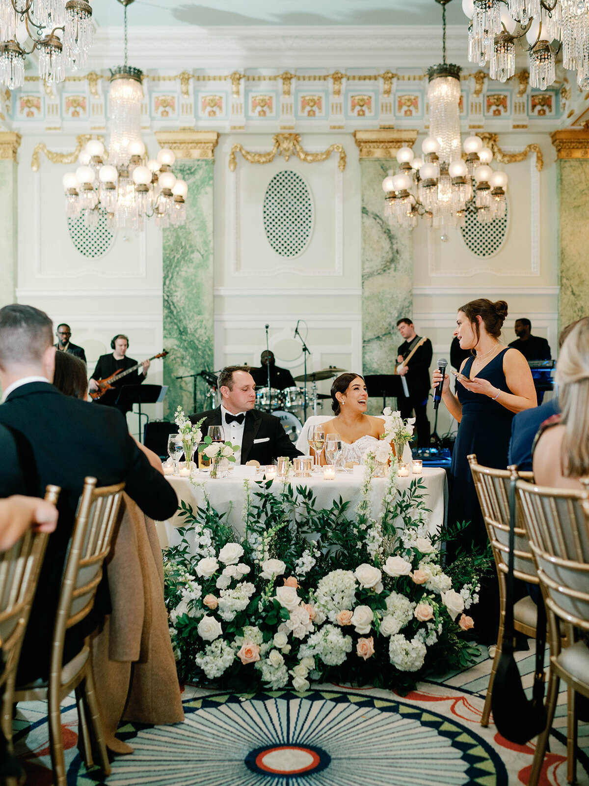 Wedding toast by sister as bride laughs