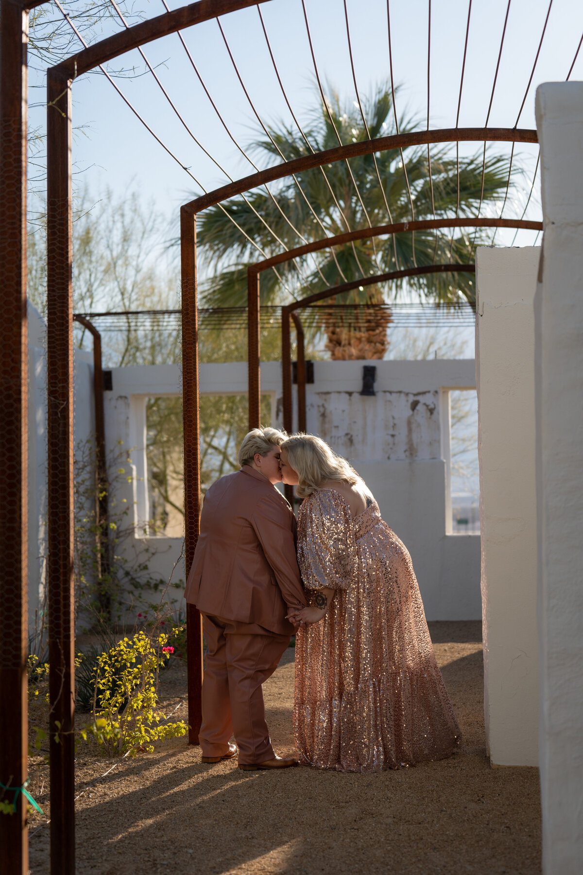 A couple kissing in a small garden