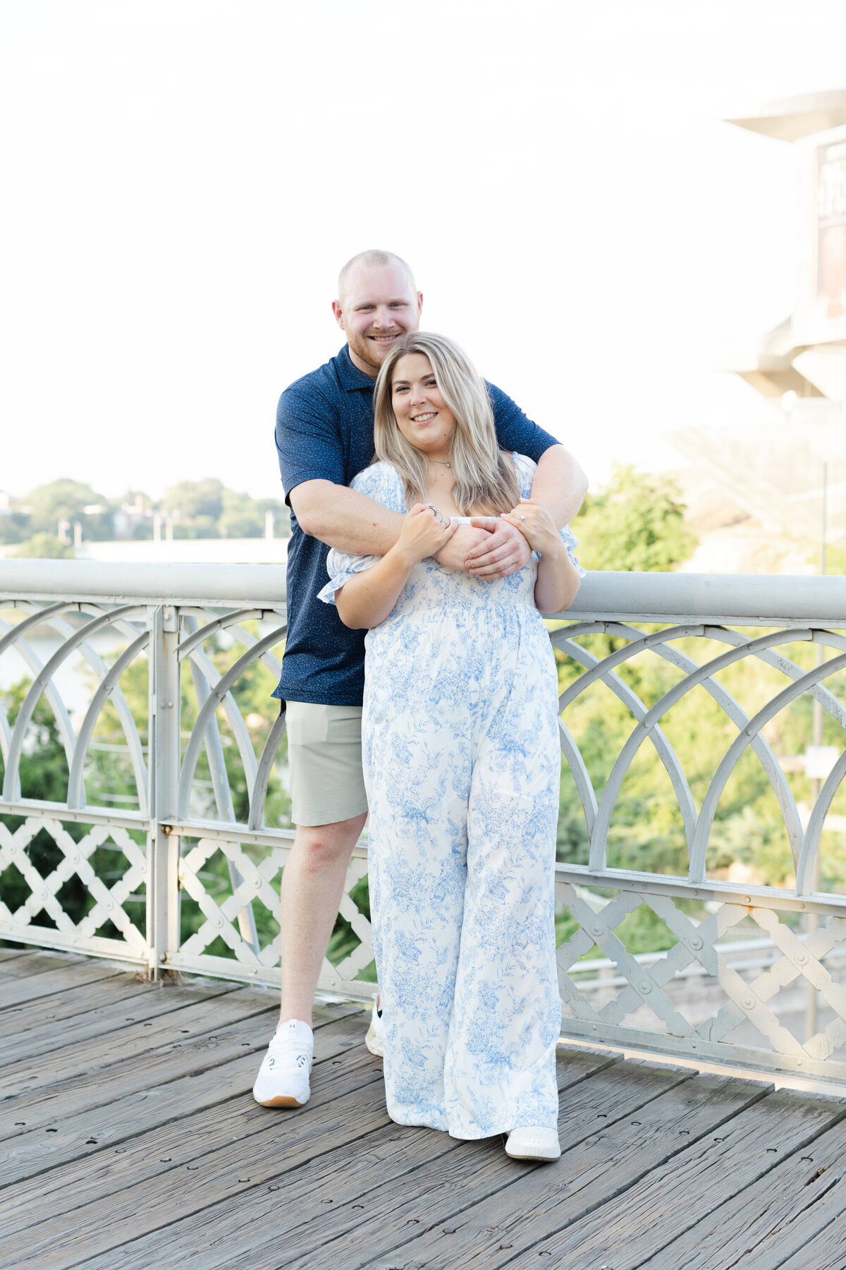 engaged couple hugging on the Walnut Street Bridge