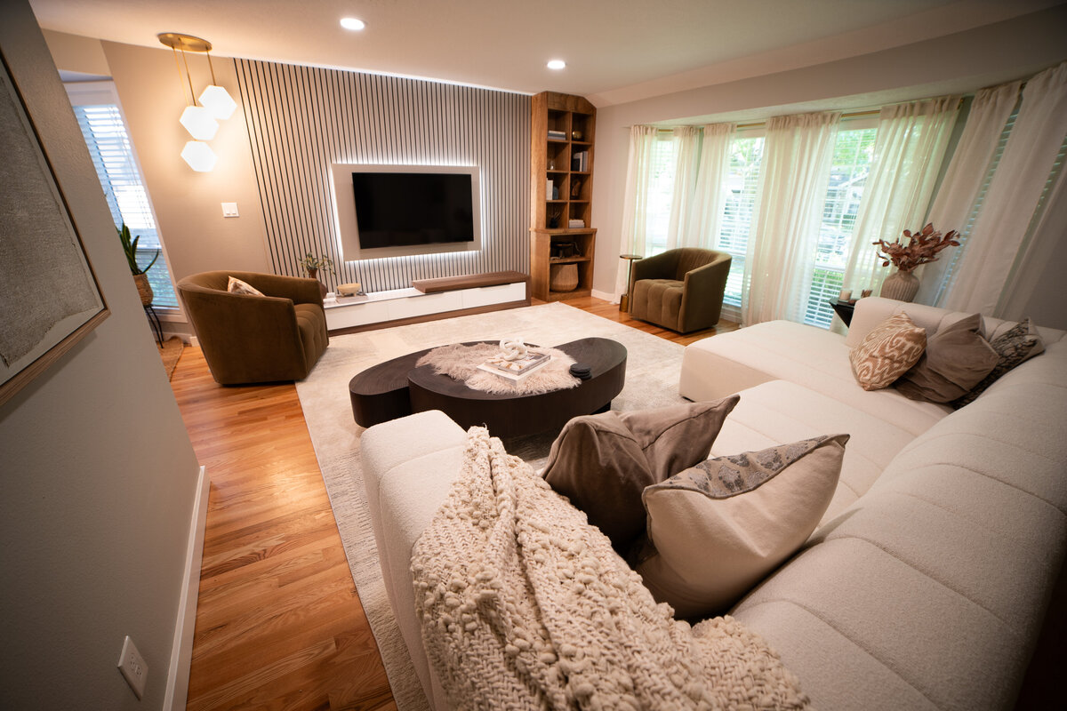 luxury great room with two white sofas fire place gold coffee table