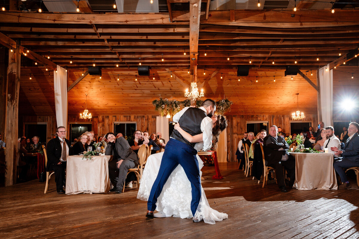 first dance on the dance floor inside of the barn at shady elms farm