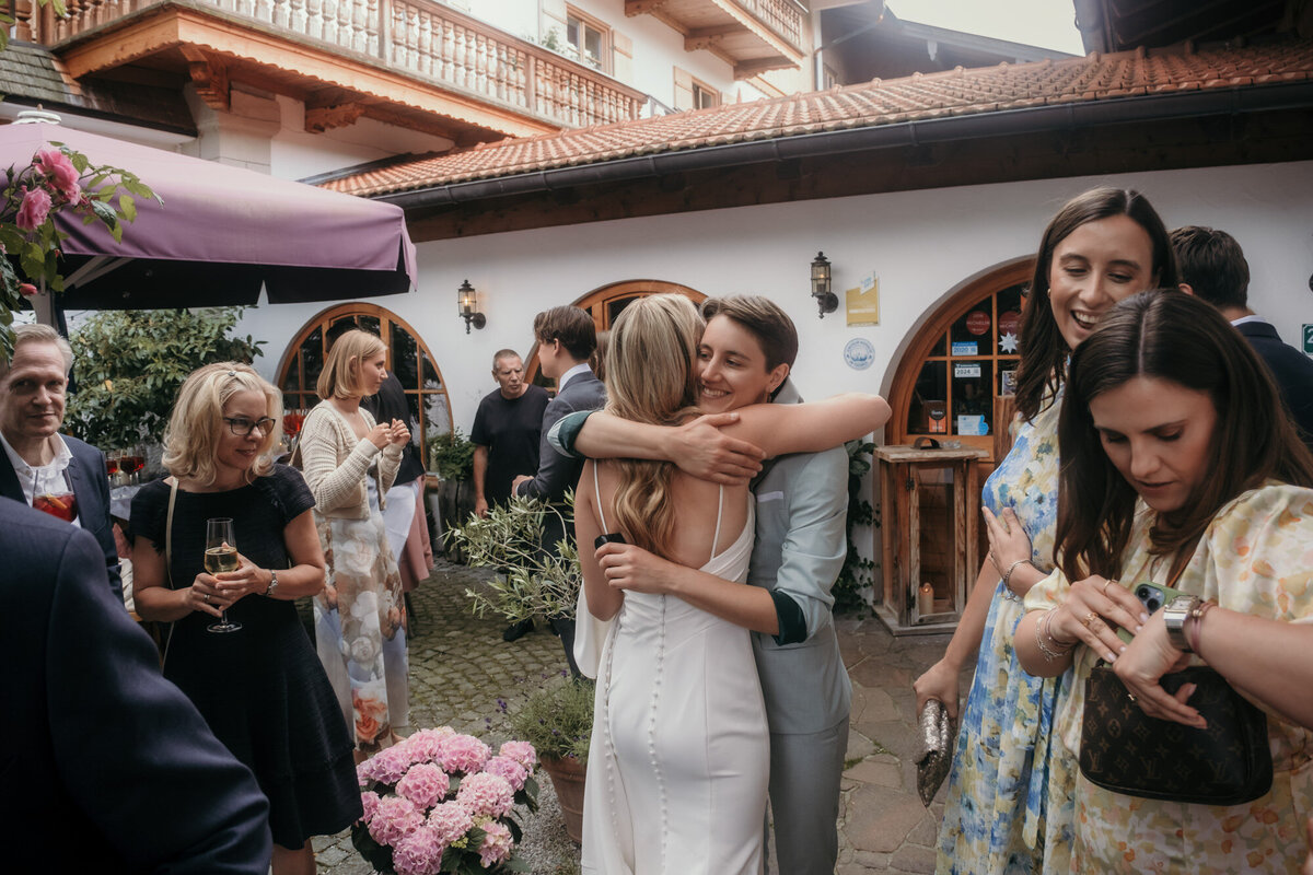 The guests congratulate the bride and groom in this candid wedding shot.