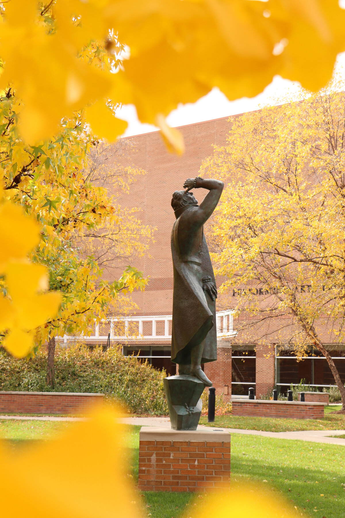 102520 marshall fredricks outdoor museum arbury fine arts statue framed by fall leaves tall format