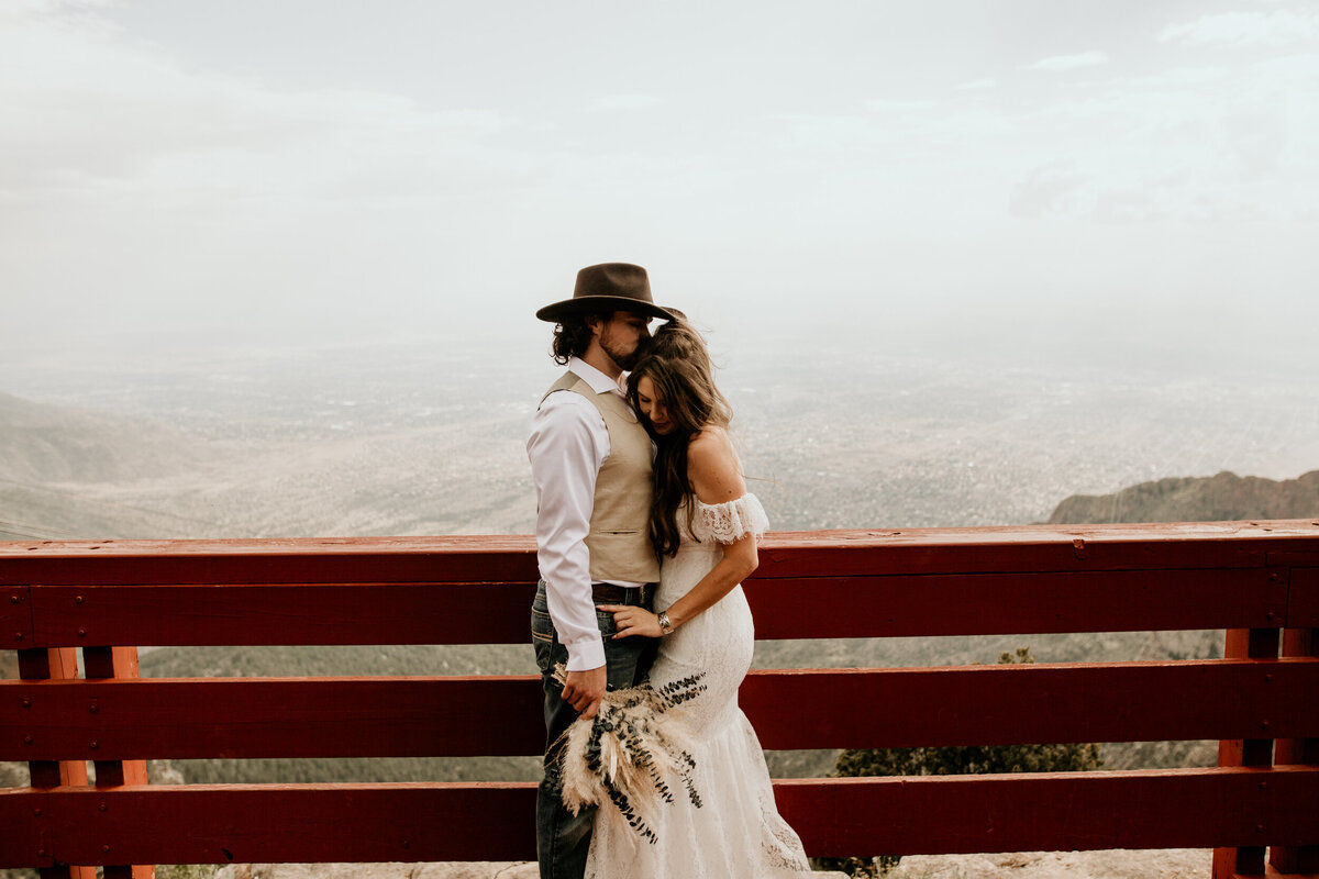 Bride and groom hugging intimately at the Sandia Peak Tram