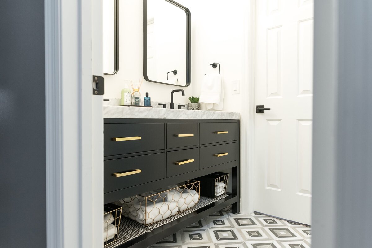 dewine design orlando interior designer modern lakehouse bathroom with black vanity with gold handles