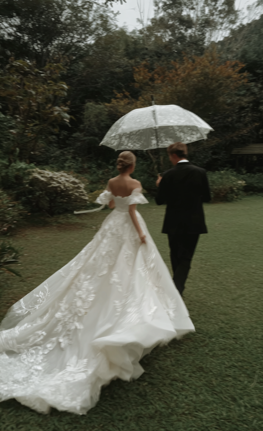 u8487914977_a_couple_in_wedding_attire_holding_an_umbrella_an_af9f44df-3f37-4d48-b41a-0fead8792da4_0