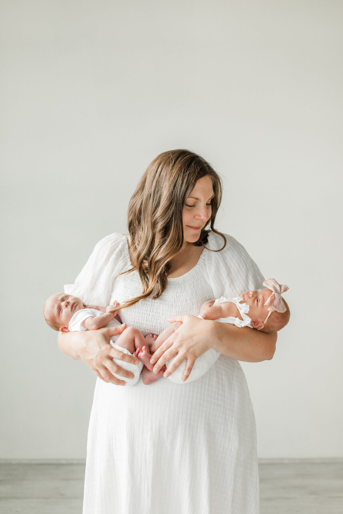 Mother in white holding her twins