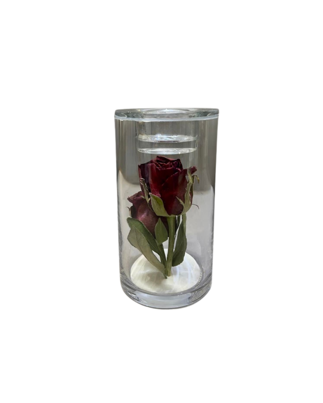 Funeral flowers preserved in candle holder.
