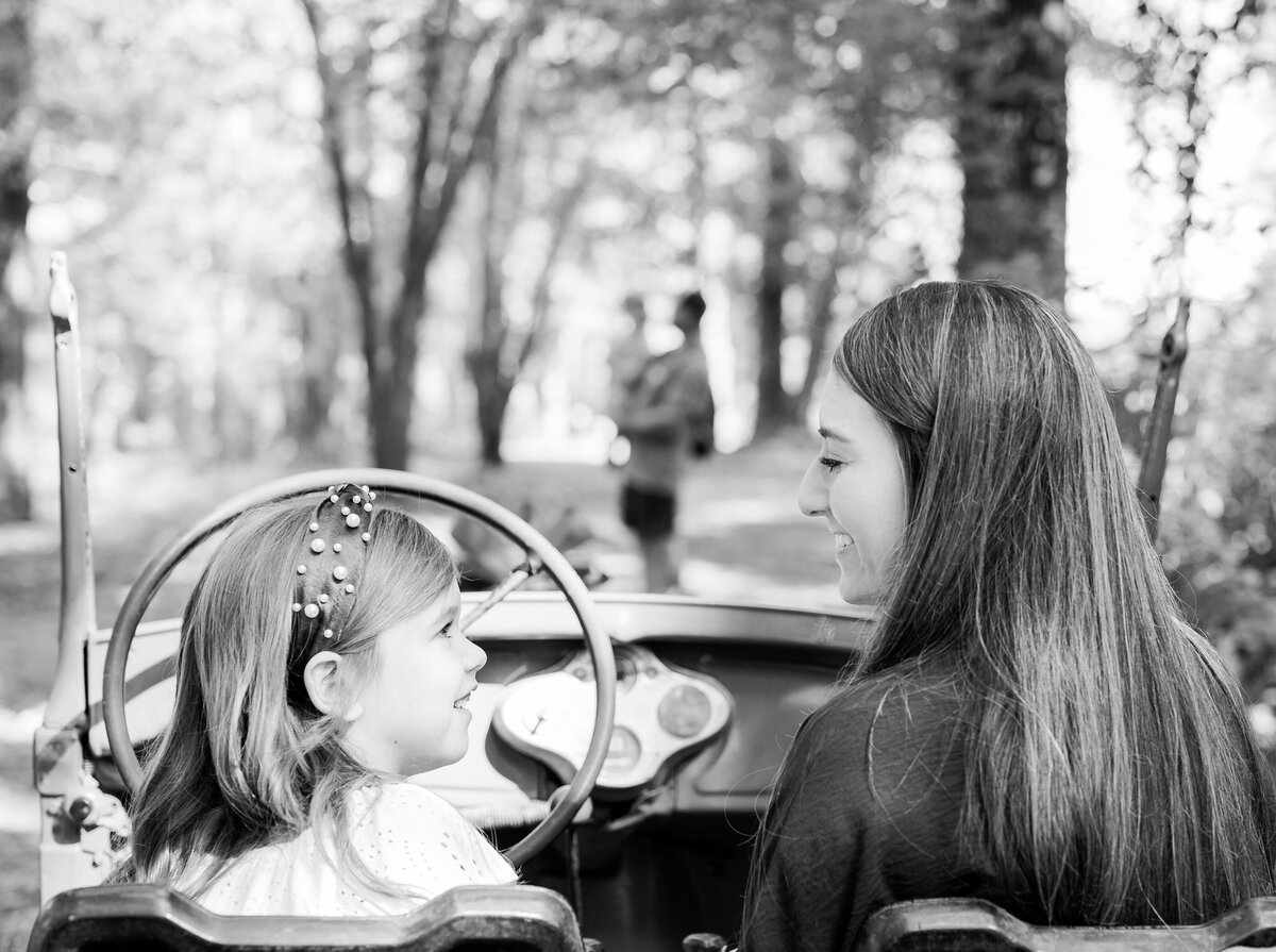 Mother & daughter taking a moment while daddy & brother look on. Sweet family sessions. Serving Bainbridge, GA, Tallahassee, FL & surrounding areas. 