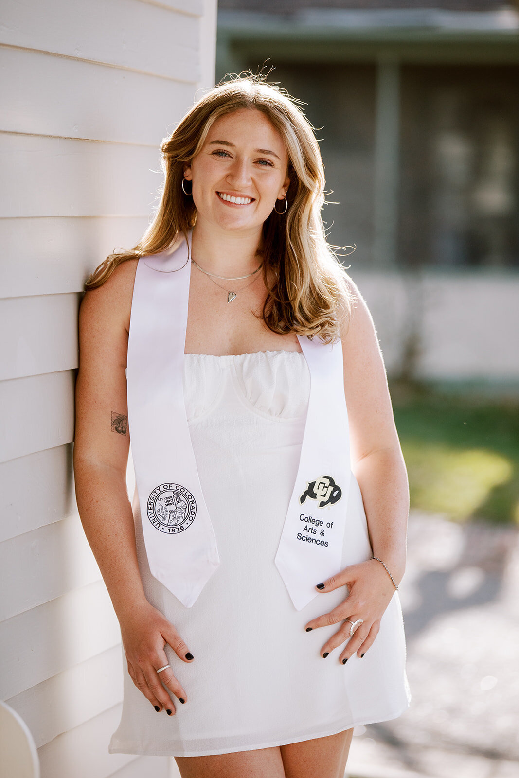 woman in white dress and college sash