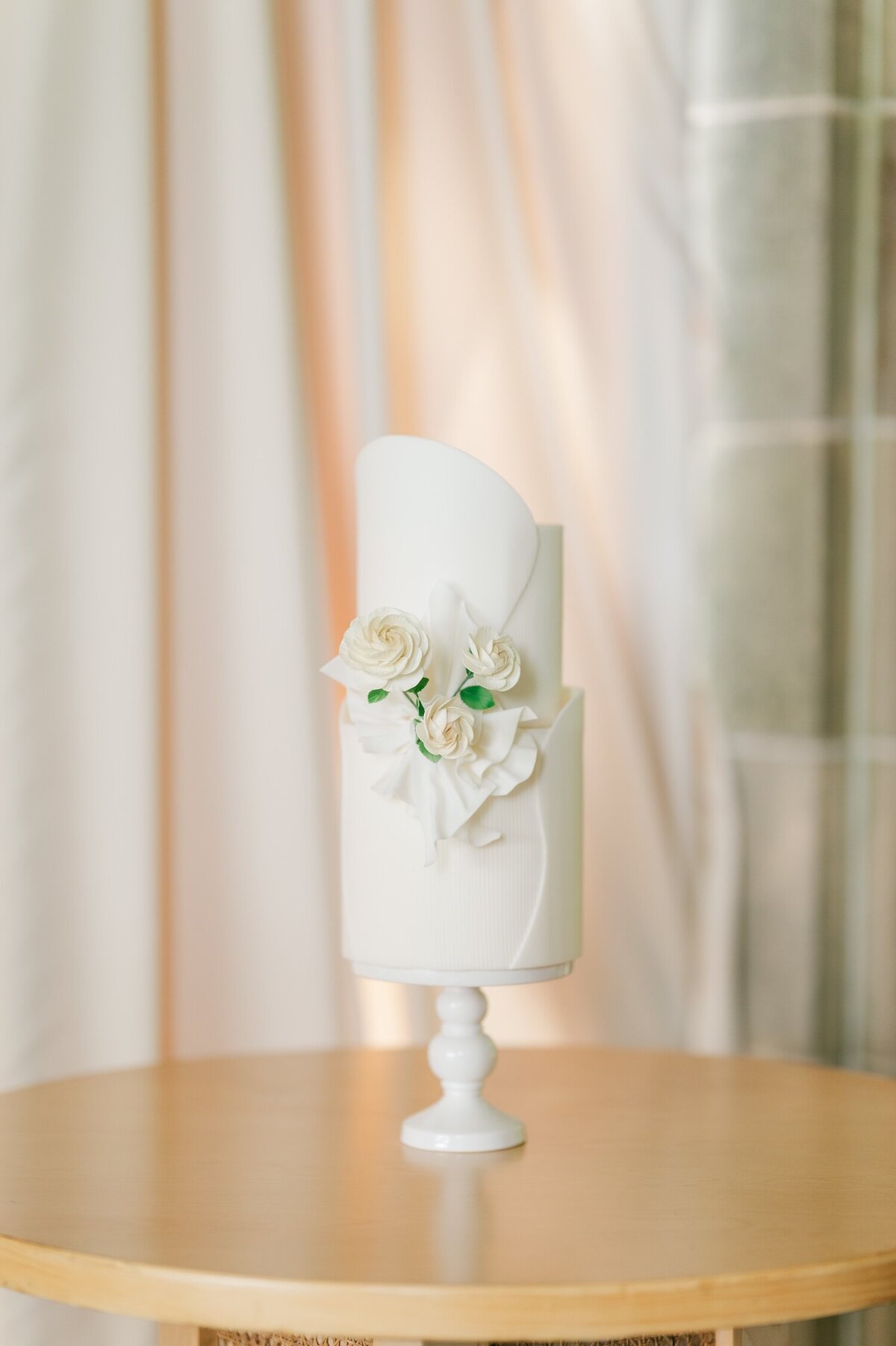 A beautiful white cake with pastel florals. 