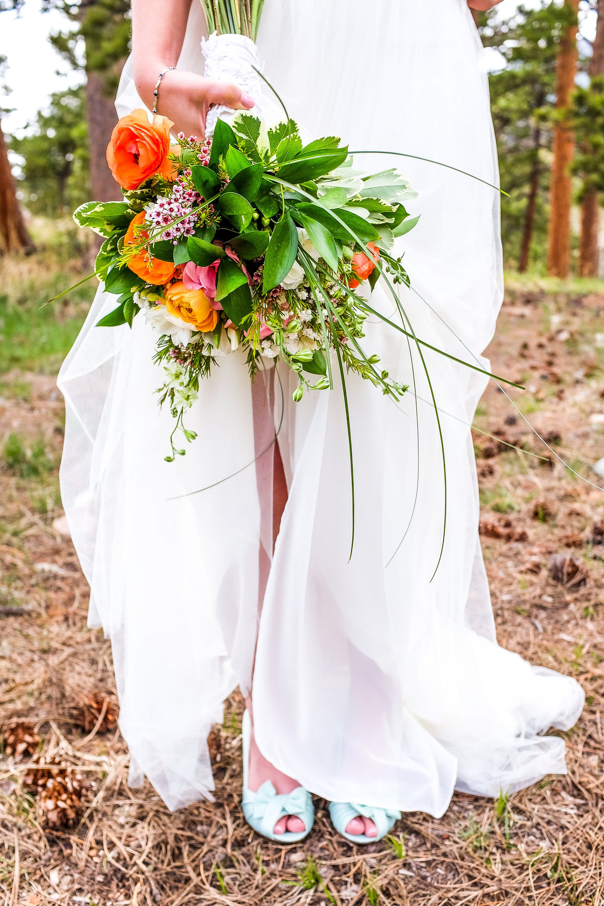 bride holding her tropical bouquet
