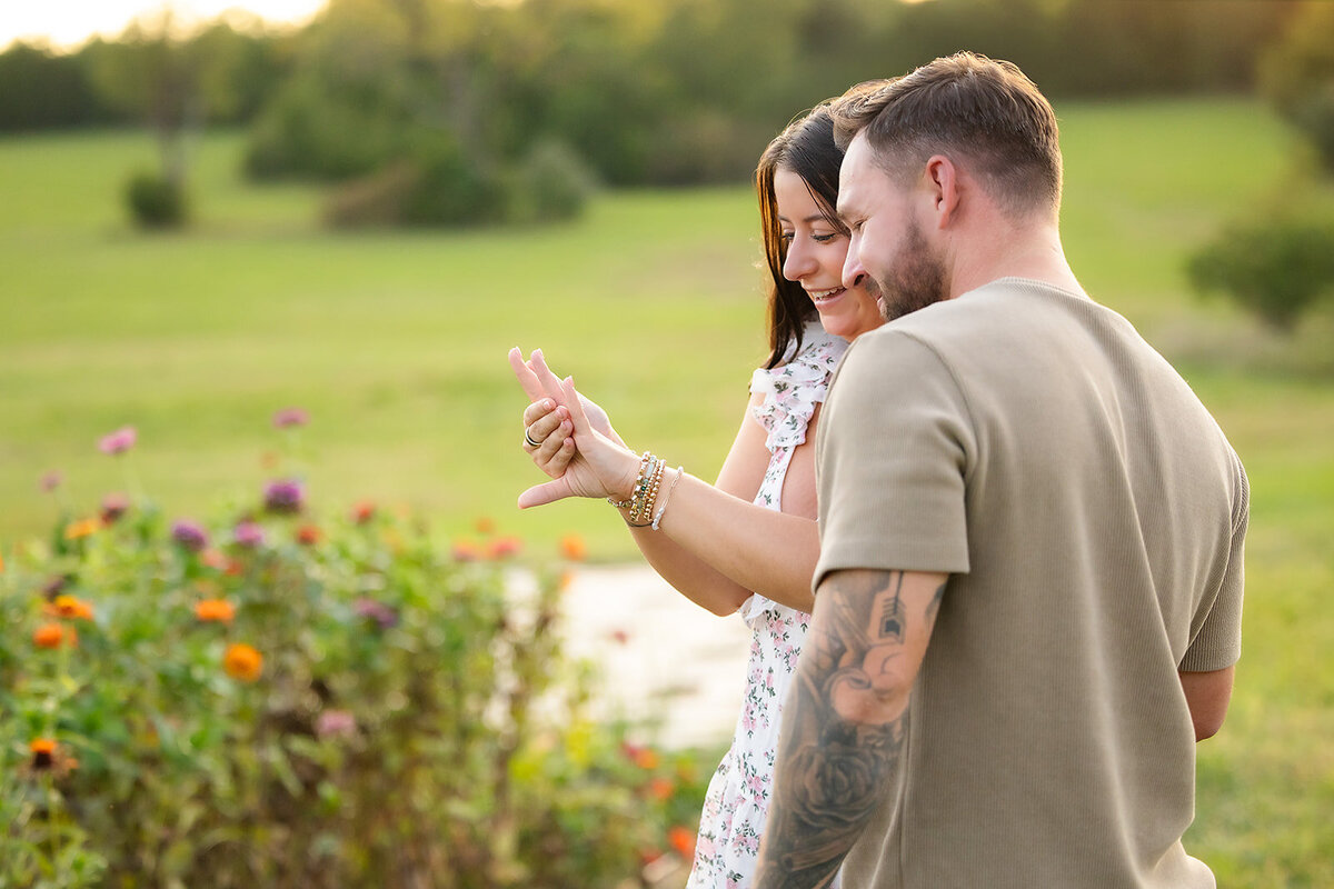 man and woman looking at engagement ring