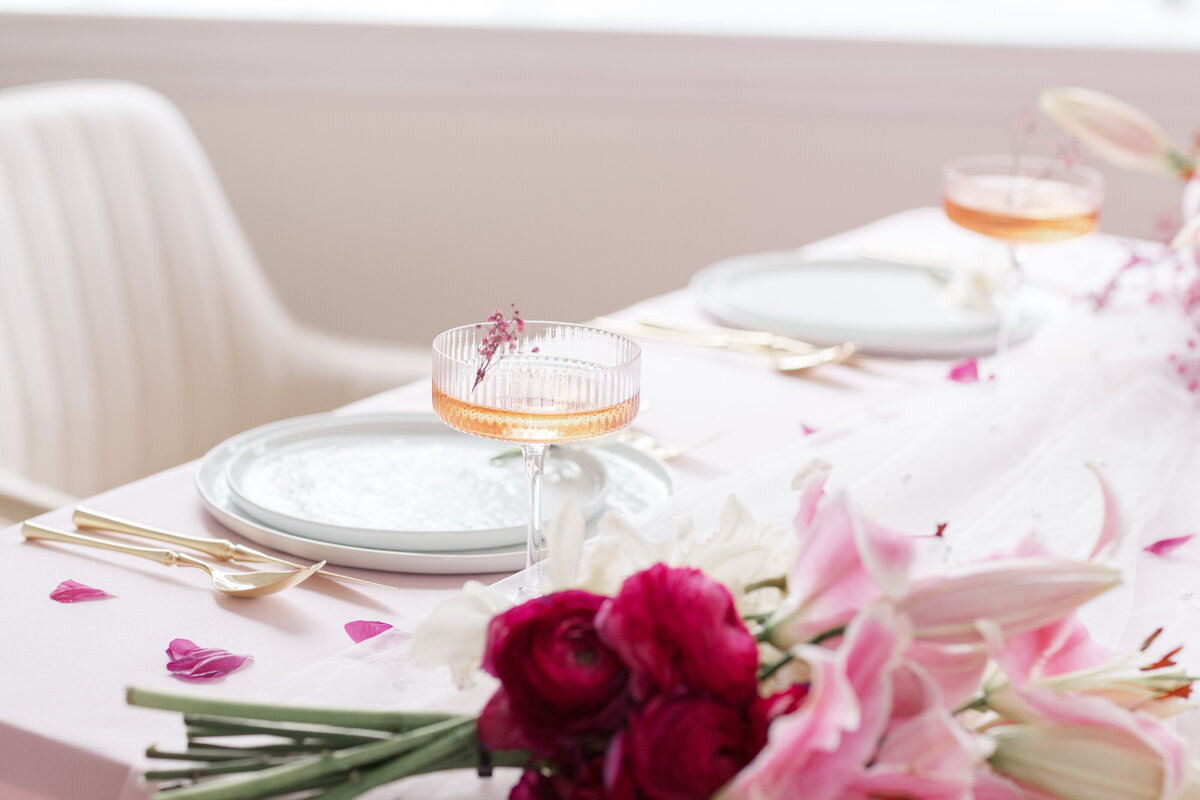 wedding table with pink florals and pink cocktails