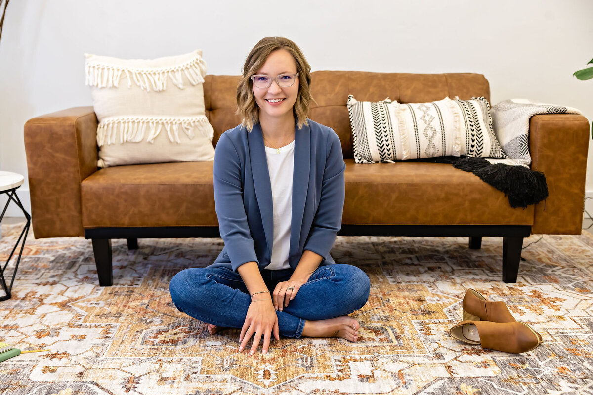 Elizabeth Rose, a millennial mom in a blue coat, certified holistic nurse, craniosacral fascial therapist, and integrative wellness coach.