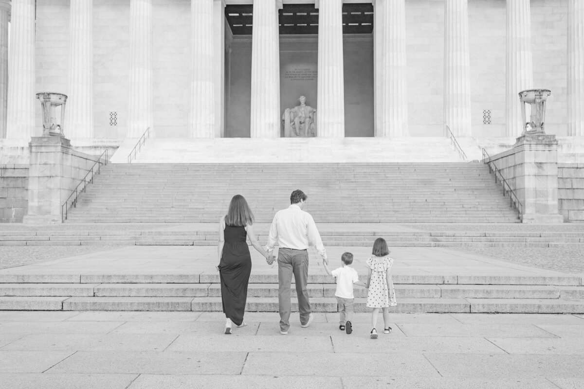 family of 4 walking to Lincoln Memorial taken by family photographer in Northern Virginia