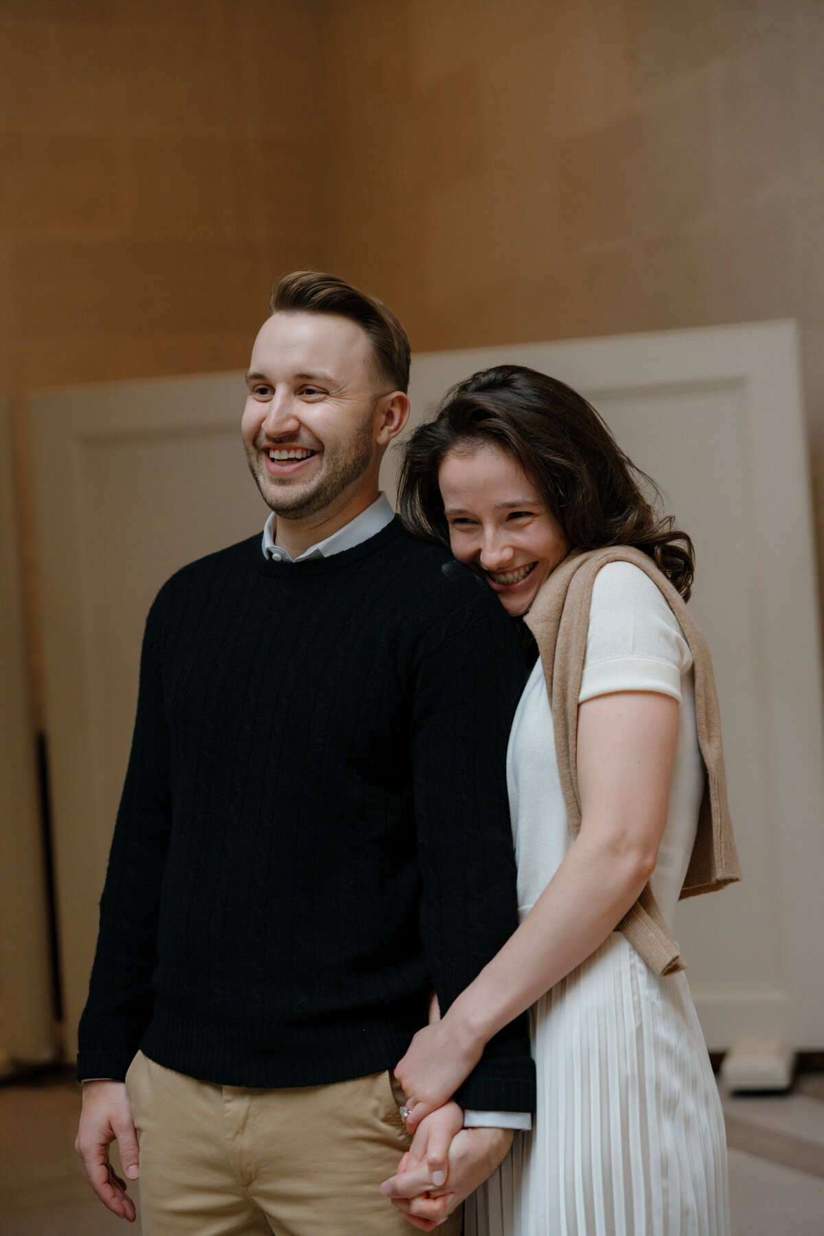 A couple holding hands and laughing