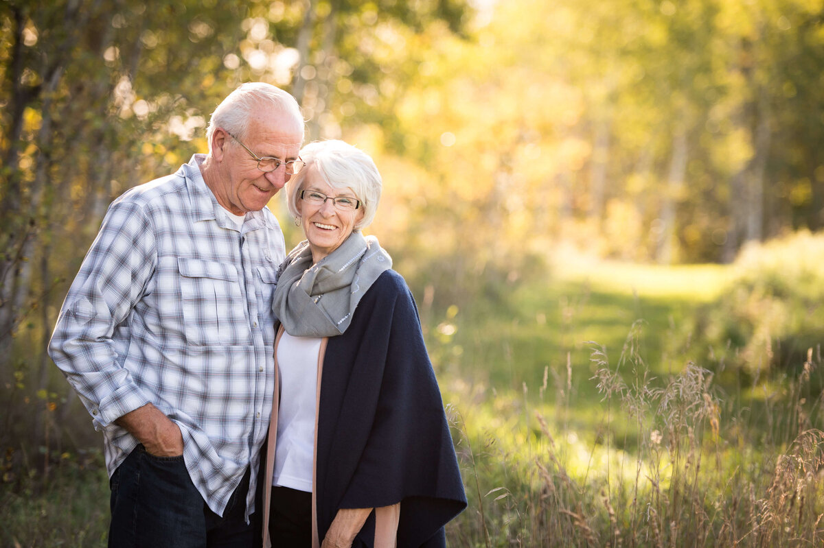 a portrait of grandma and grandpa taken in a field at sunset by Ottawa Family Photographer JEMMAN Photography