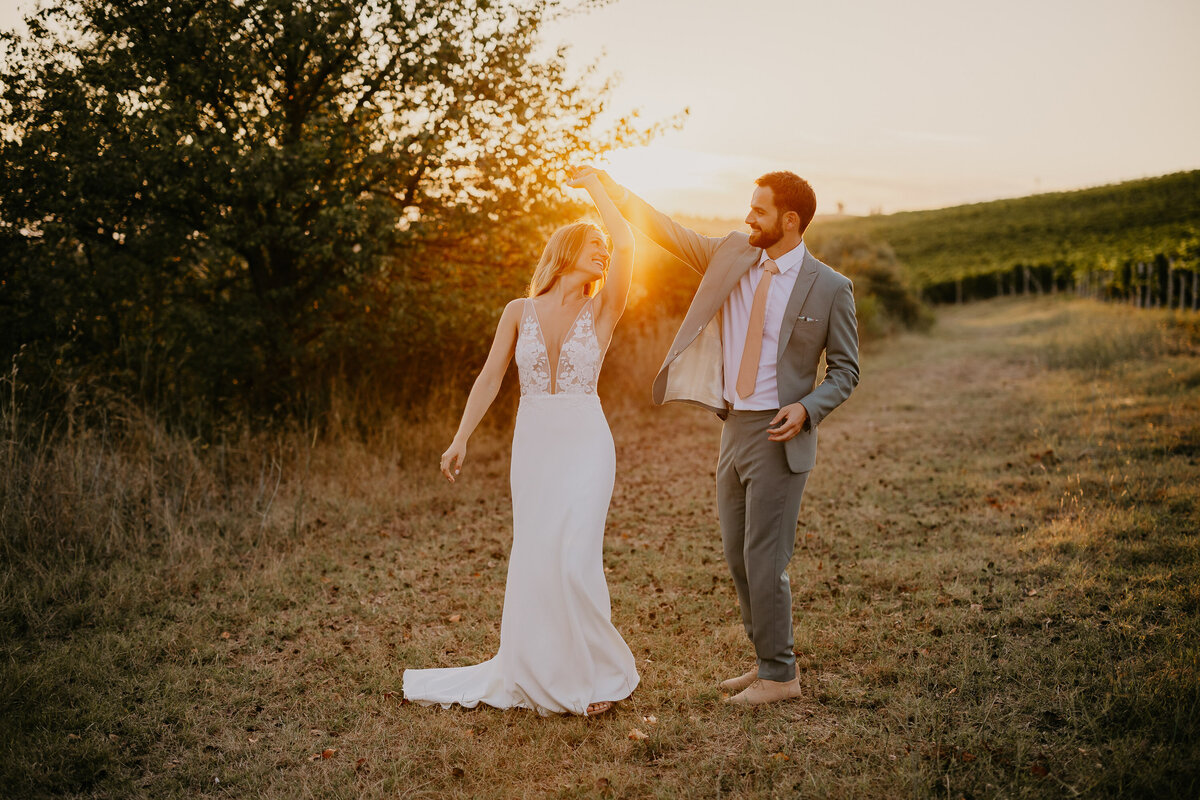 Couple dancing in the vineyards at sunset at Borgo Divino, Tuscany wedding photographer.
