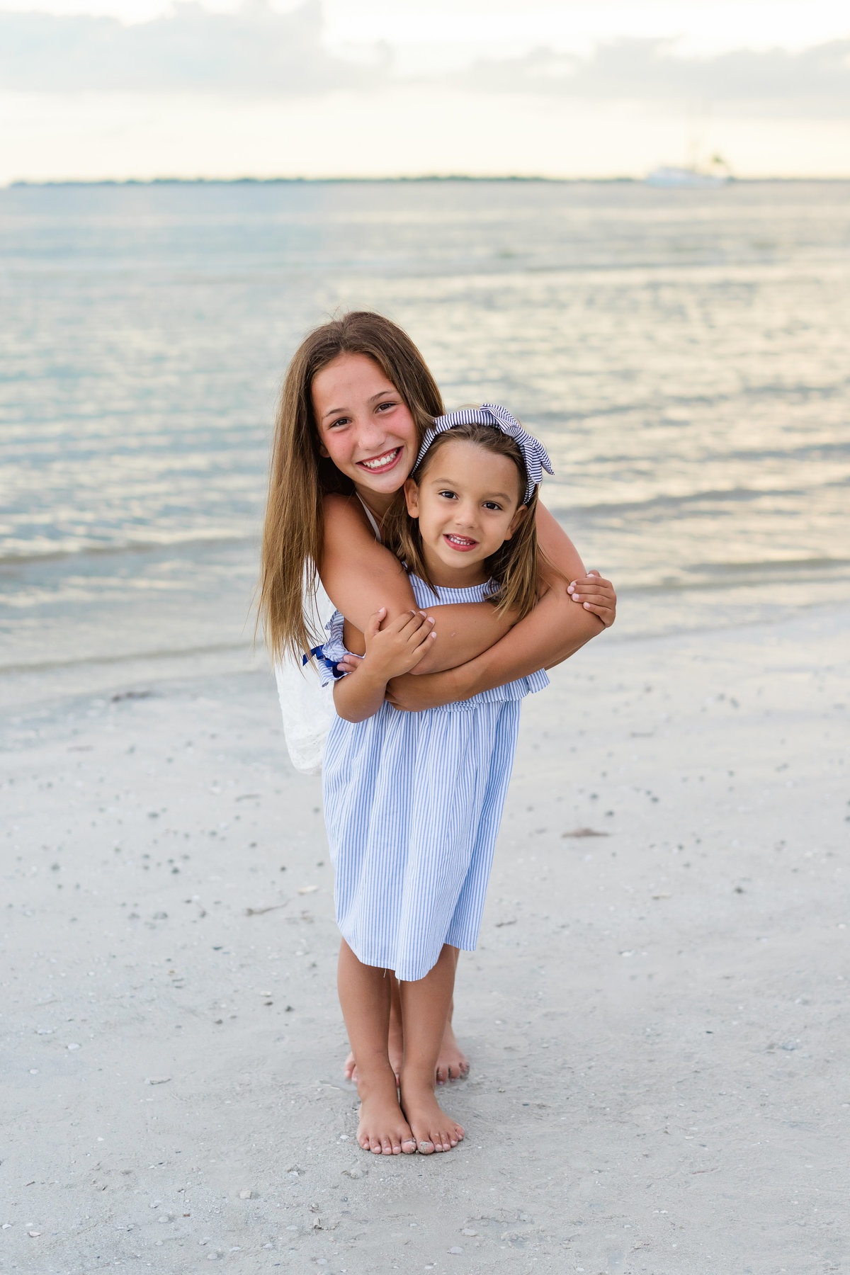 Two sisters hug each other on Fort Myers Beach Florida