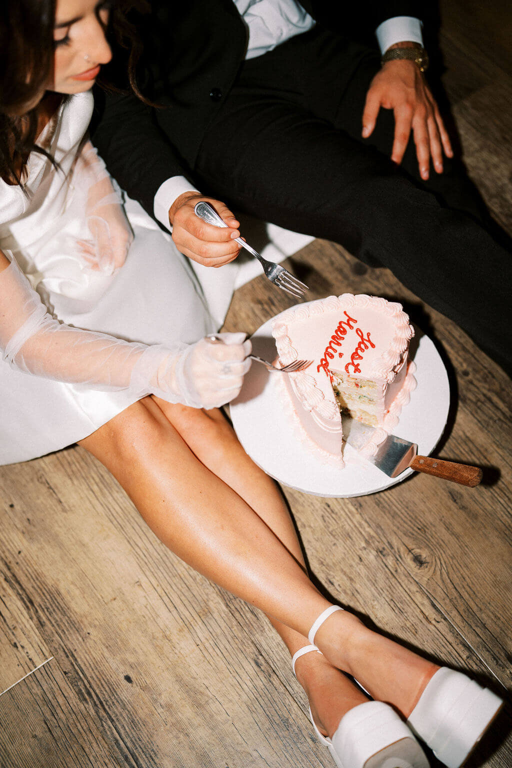 Bride eating her wedding cake on the floor