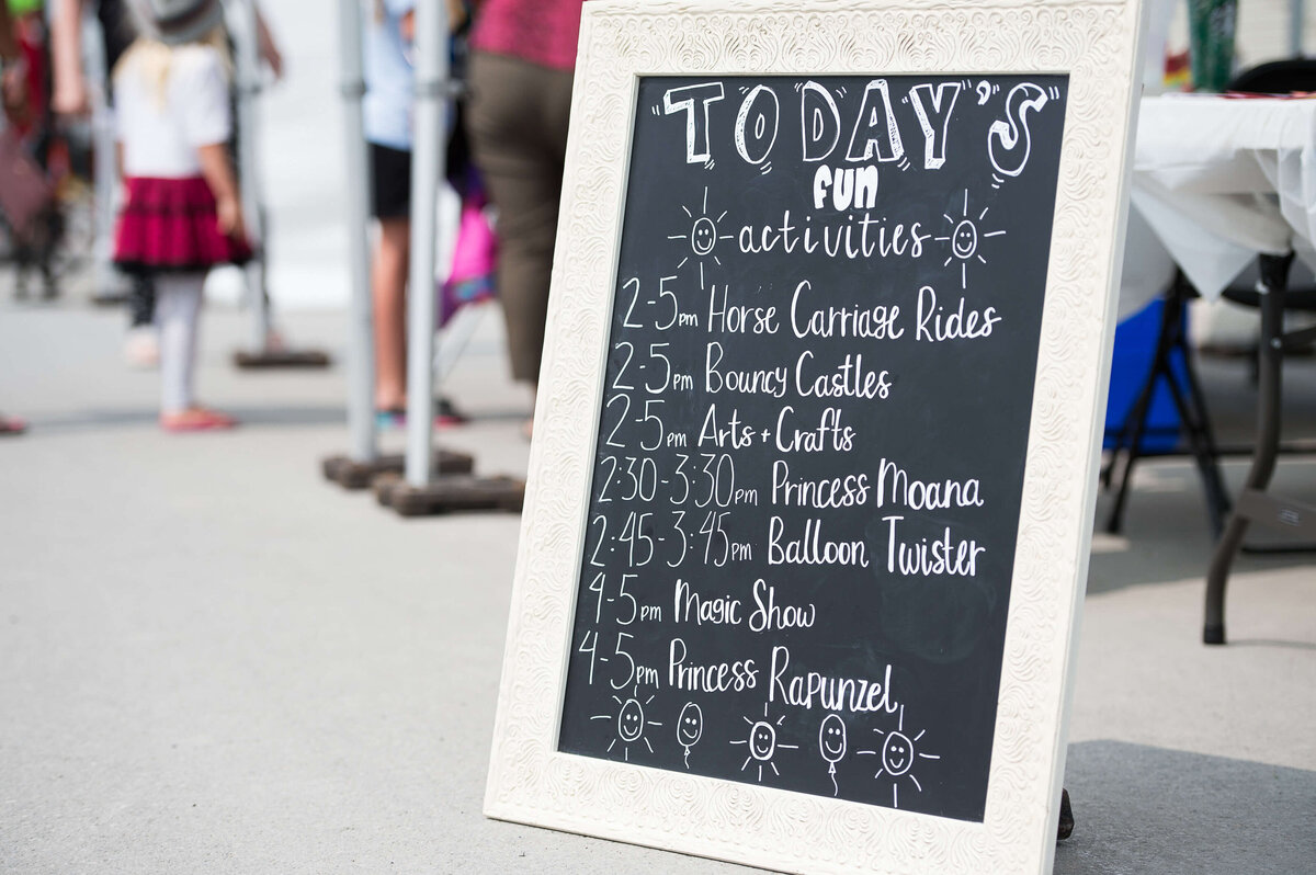 a chalkboard with a schedule of children's events.  Captured by Ottawa Event Photographer JEMMAN Photography COMMERCIAL during a corporate children's event