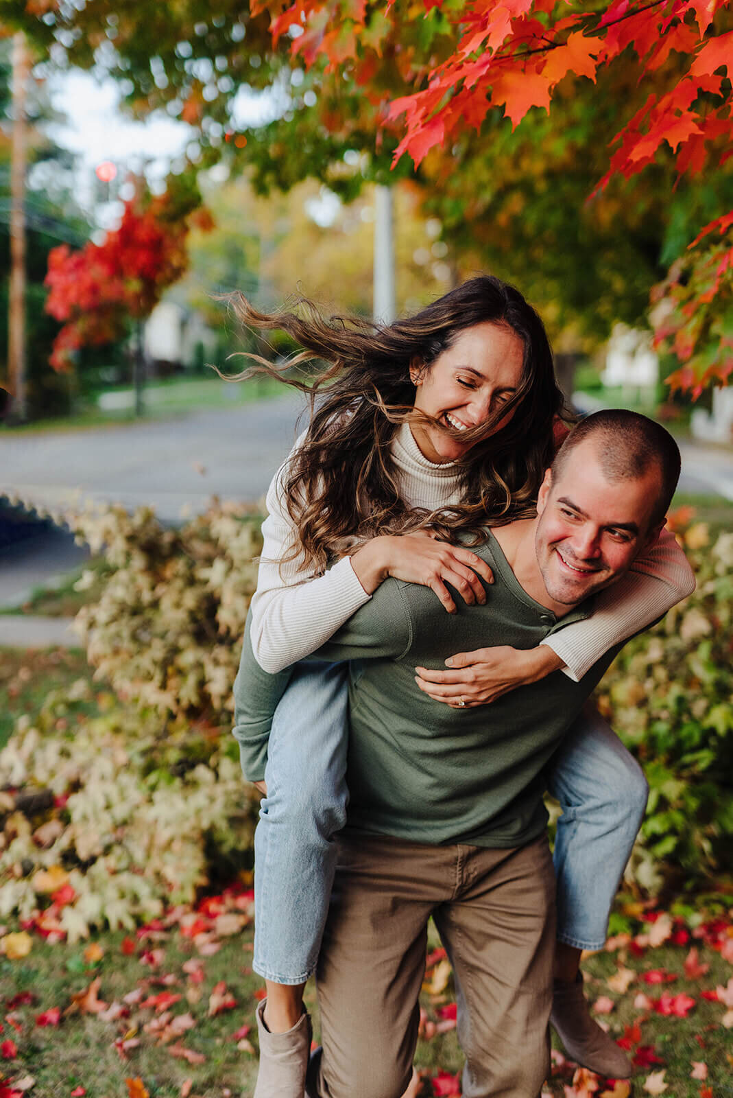 Man giving woman a piggy back at Finger Lakes engagement session