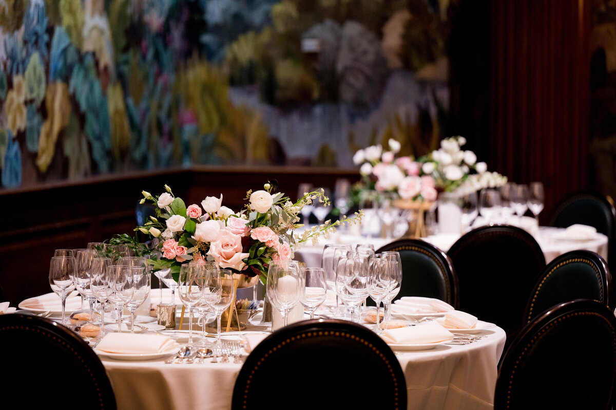low centerpieces on the tables at a wedding reception with flowers and pin lights