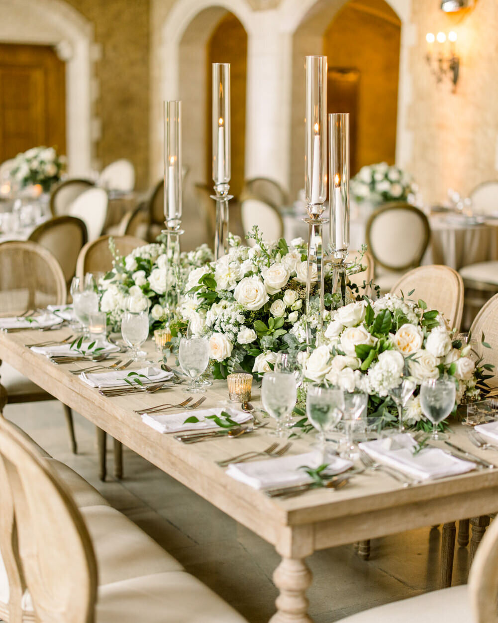 This elegant photograph showcases the luxurious reception table setup in Mount Stephen Hall at the Banff Springs Hotel. The refined decor and grand ambiance of the hall create a sophisticated and timeless atmosphere for the wedding celebration.