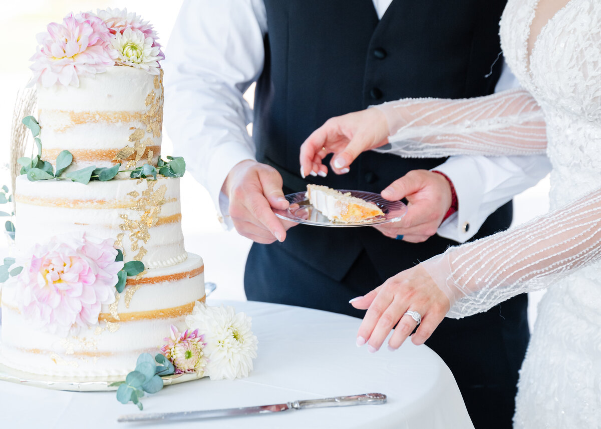 close up of wedding cake cutting at snohomish venue summer outdoors