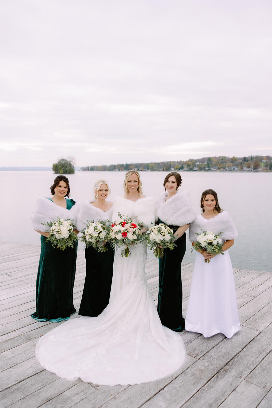 Bride with bridesmaids standing on deck at The Lake House on Canandaigua, Finger Lakes, NY