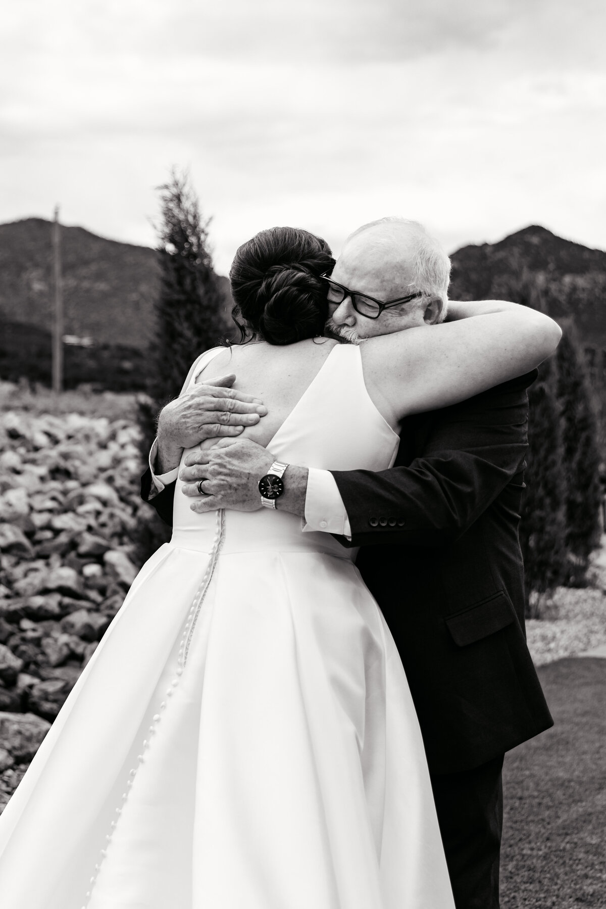 Shannon Lee, from Love Like Wild Photography, captures a heartfelt embrace between a bride and an older gentleman.
