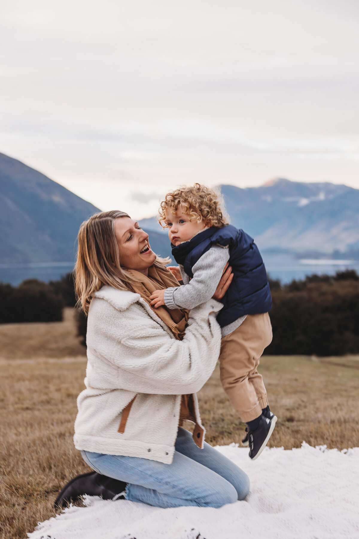 mum liften her son in the air during a family photoshoot in wanaka with Captured by Bie