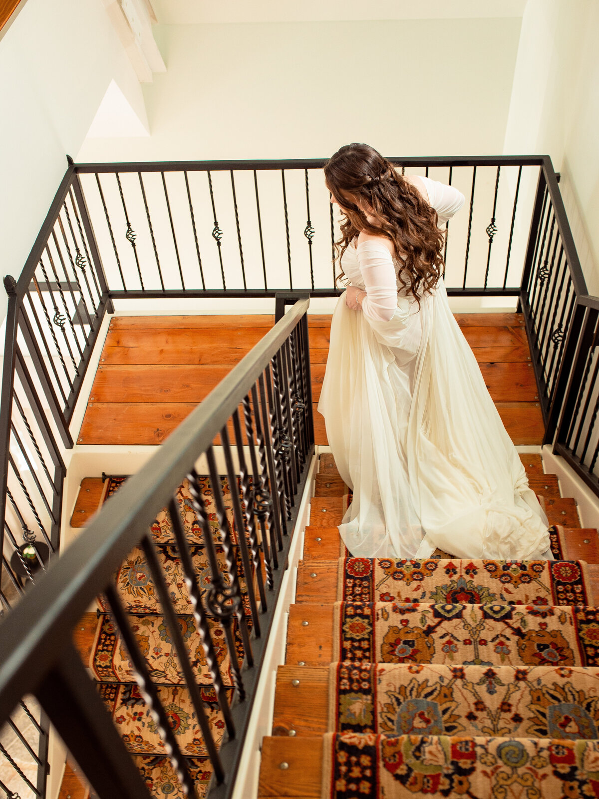 Bride walks down the stairs.