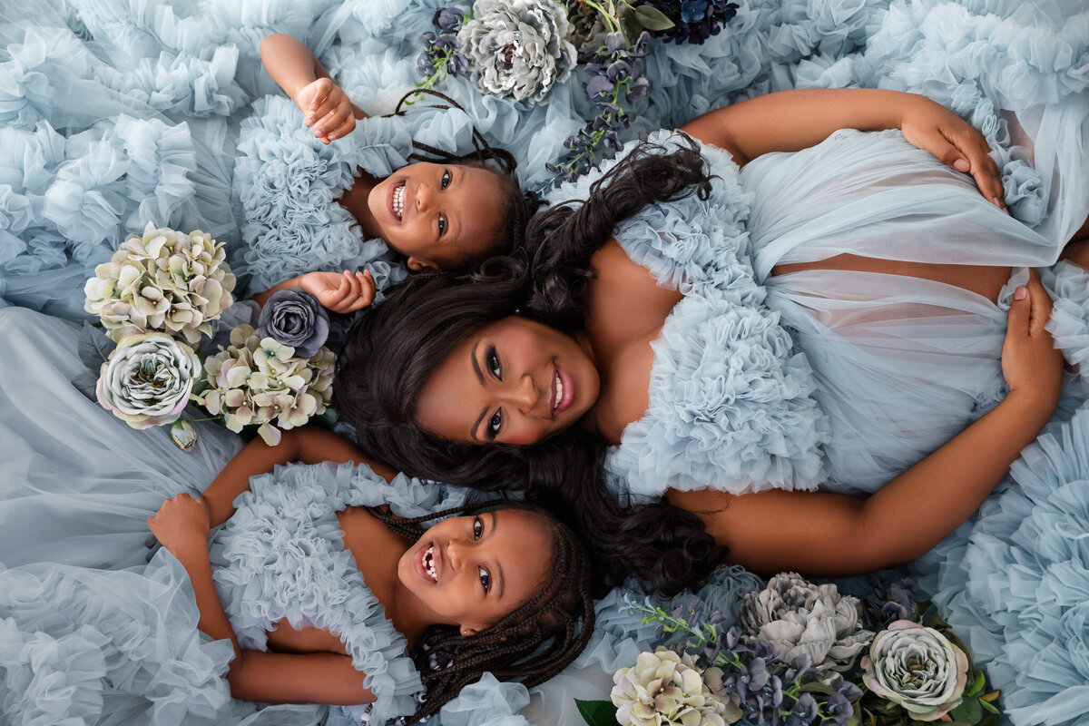 mom and two daughters maternity photos with blue dresses