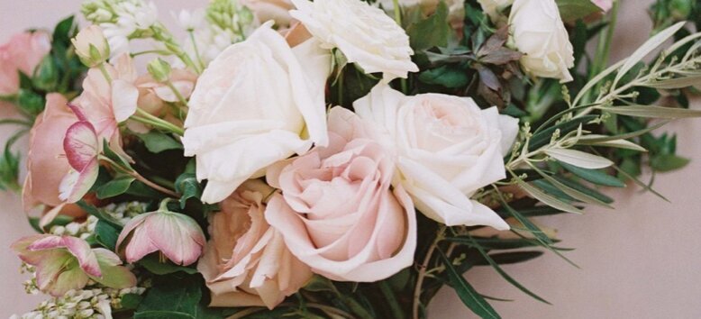 Blush and white rose wedding florals with greenery