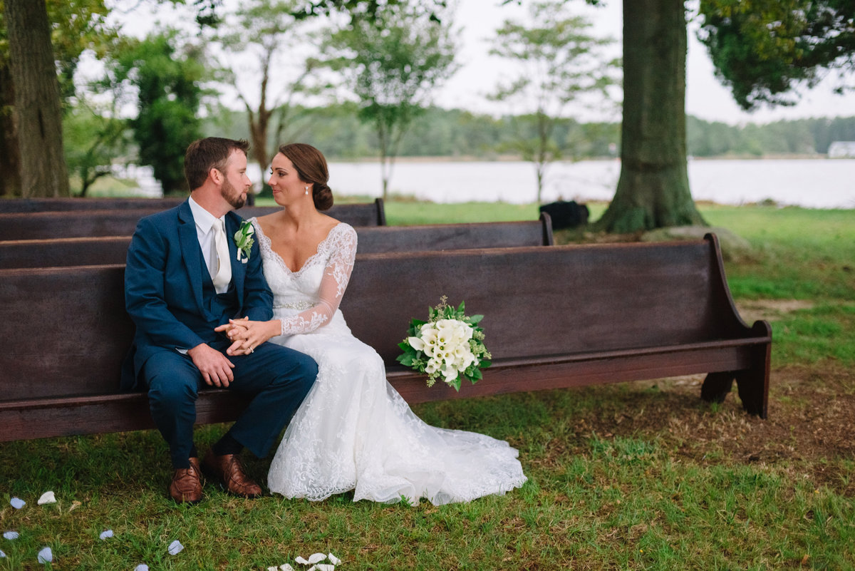 cambridge maryland waterfront wedding photographer bride and groom on bench